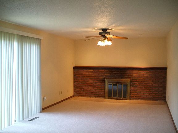 Family room with wood burning fireplace and sliding door to back yard.