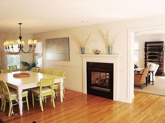 View of dining room with gas fireplace for both rooms