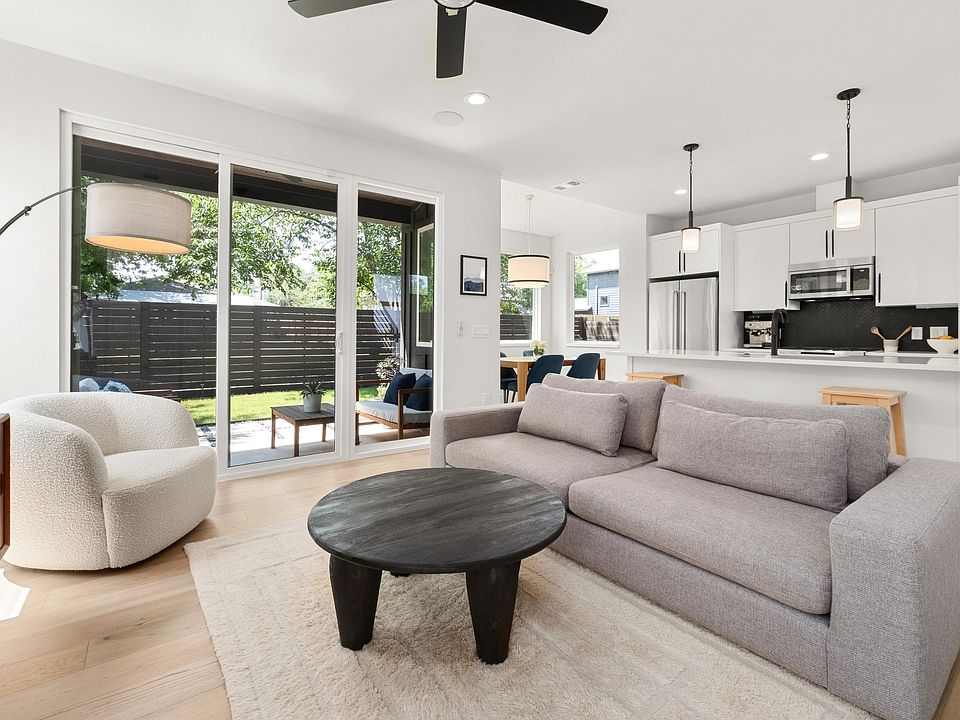 Living room is framed by sliding glass doors.