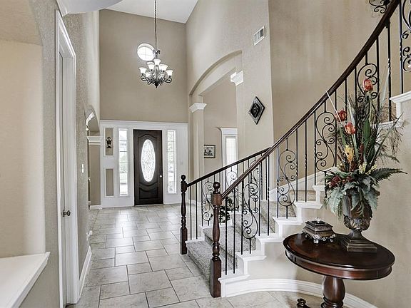Wrought iron staircase, neutral colors, light fixtures and art niche are just a few of the amazing characteristics in the home.