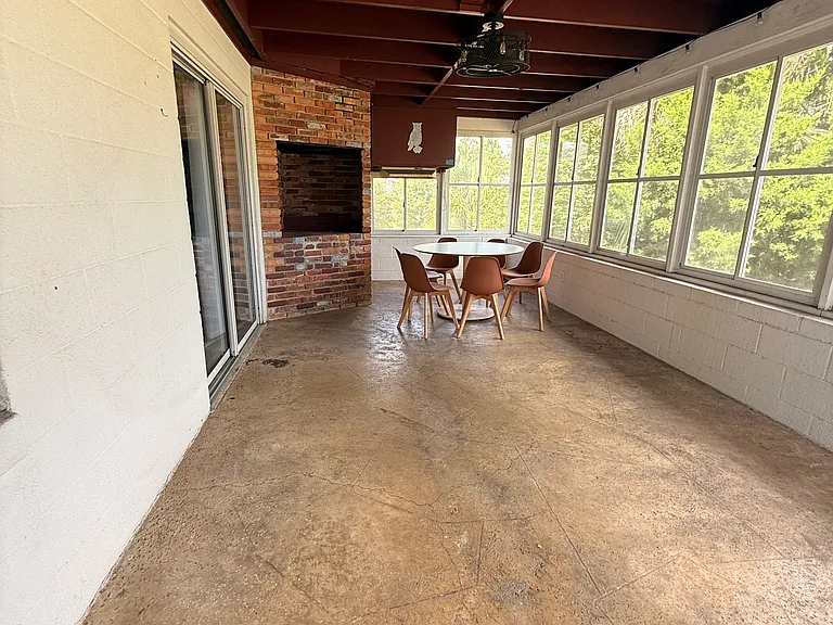 Florida sun room overlooking fenced in backyard.