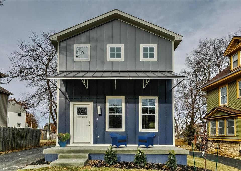 Front of the home features a covered front porch with room for outdoor seating and a dedicated driveway.