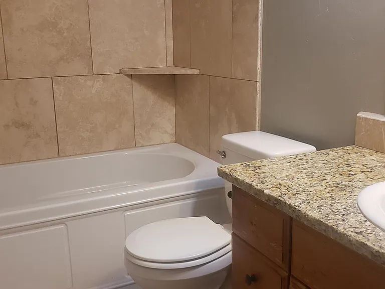 Top quality family bath with tile and granite counters.