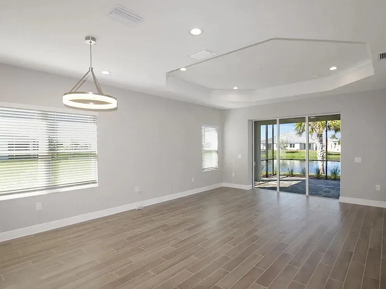 Gorgeous Great Room & Dining Room Combo. Walk out to the Oversized Lanai! The ceiling fan has been installed.