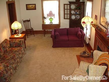 Carpeted Living Room/w Solid Wood Trim
						:
						Living Room with Gas Log Fireplace
