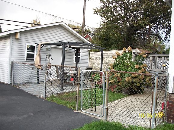 Fenced in backyard with patio