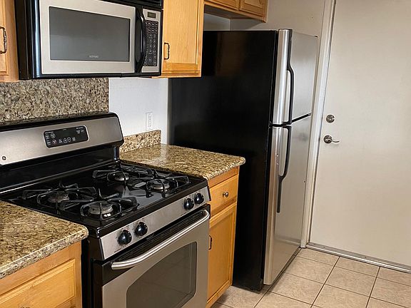 All GE Stainless Steel appliances are included. Raised ceiling with custom light fixture makes seeing what your cooking real easy.