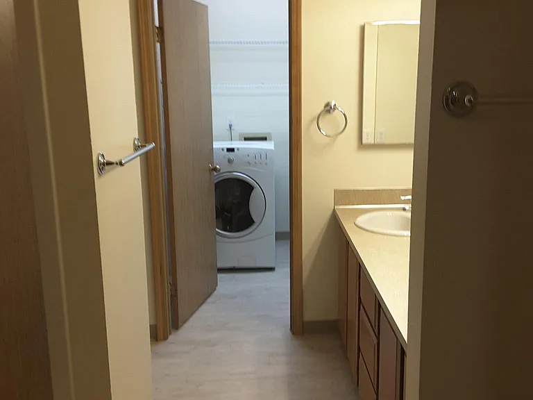Laundry room at end of bathroom