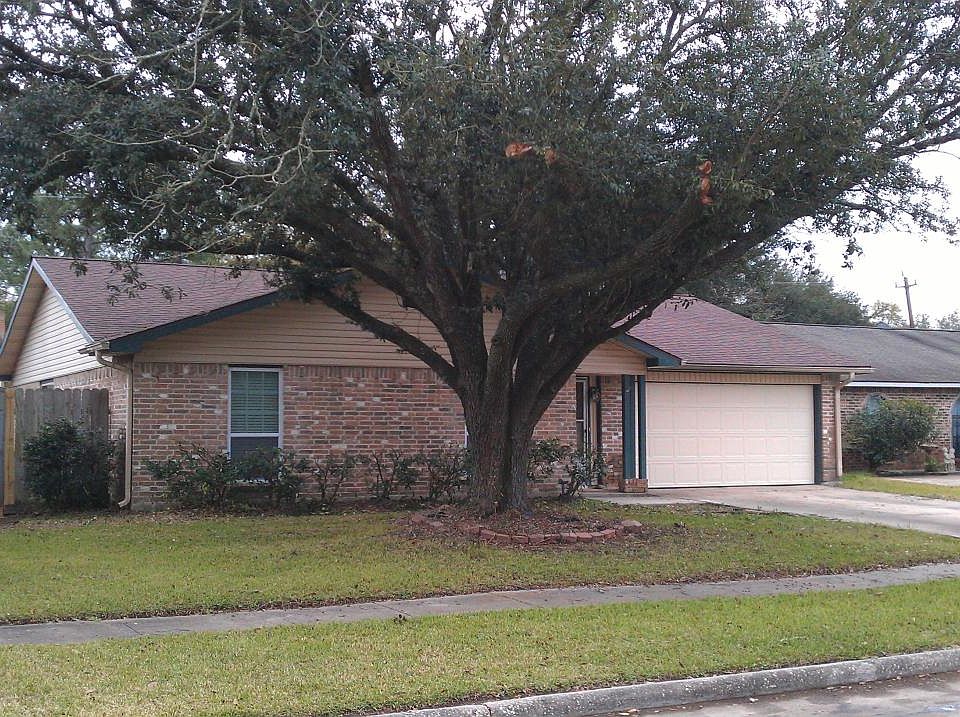 Front of the house with a large shade tree
