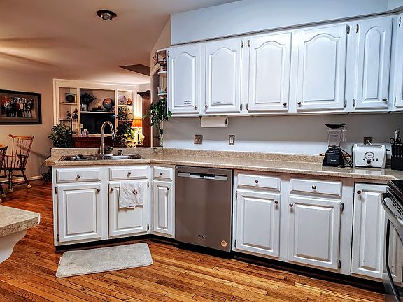 Looking into the kitchen and breakfast area from the hall. Lots of cabinet and counter space and stainless steel appliances.