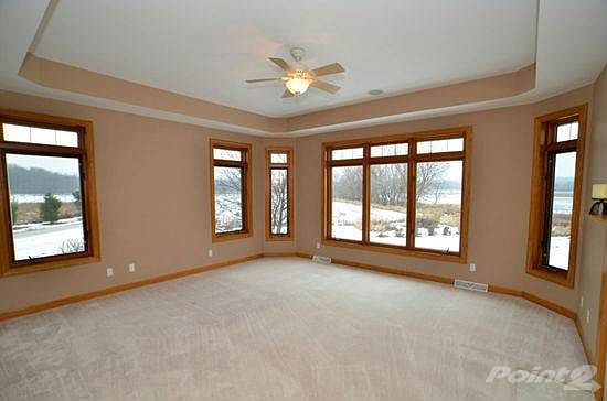 Master bedroom with tray ceilings and two-way fireplace