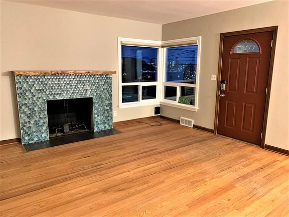 Living area with peek views of the city lights. Main entry.