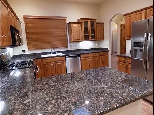 Fabulous kitchen with granite countertops and big fridge.