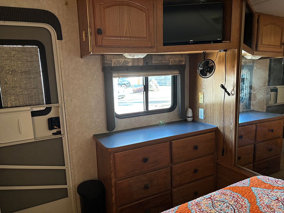 Bedroom one with exit door and chest of drawers