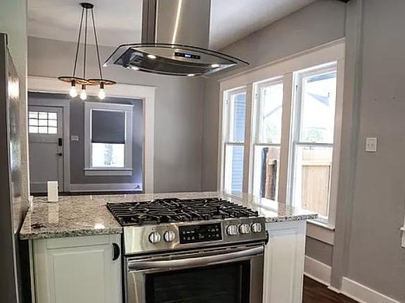 View of front door from kitchen, new stainless appliances in kitchen