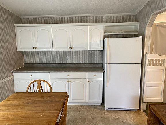 Kitchen view with refrigerator.