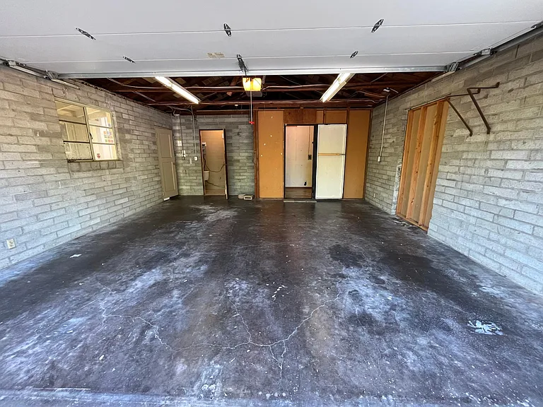 Detached two-car garage features a convenient restroom with a utility sink, walk-in storage closet and automatic door opener. A large creative workshop space is connected to the garage.