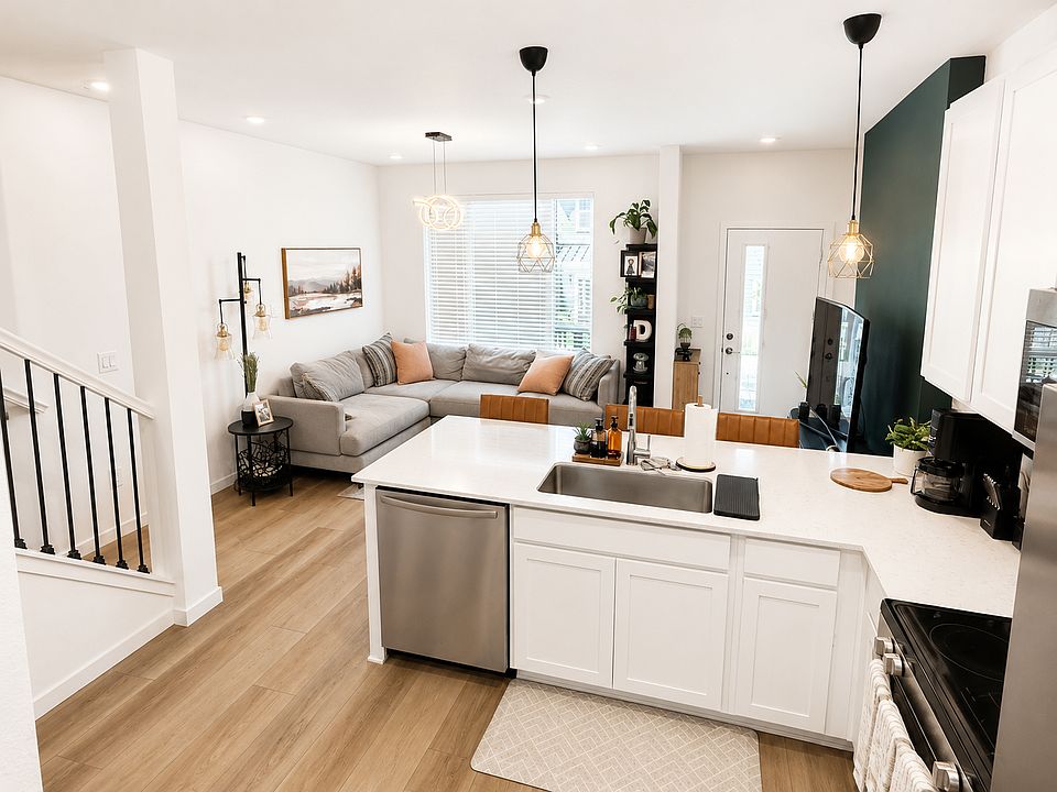 Modern kitchen featuring a double-door refrigerator/freezer, stove, microwave, dishwasher and a walk-in pantry.