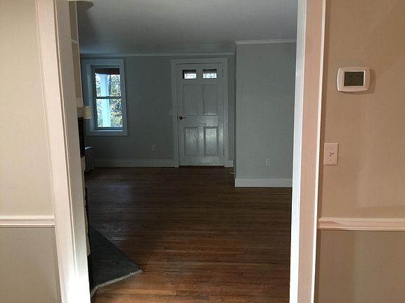 Looking into the livingroom from dining room. The front door goes out to a small outside porch.