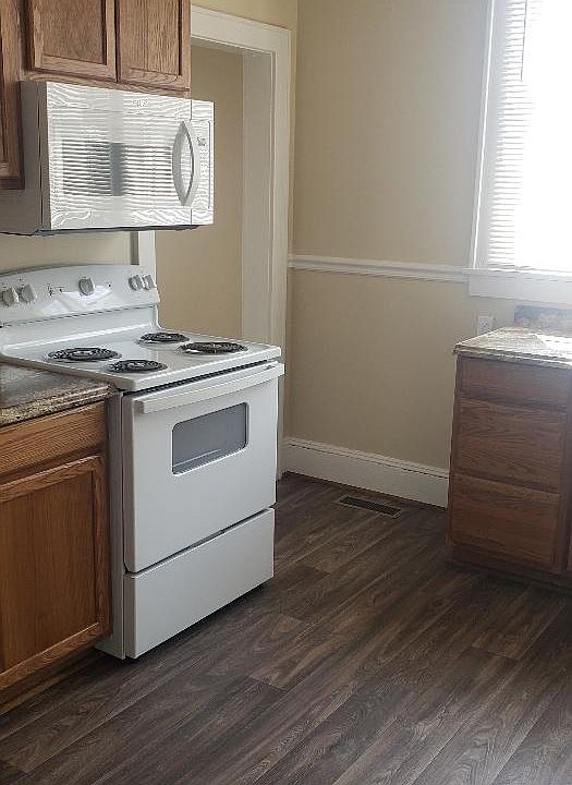 Plenty of room for dinette set in kitchen with beautiful built in cabinets
