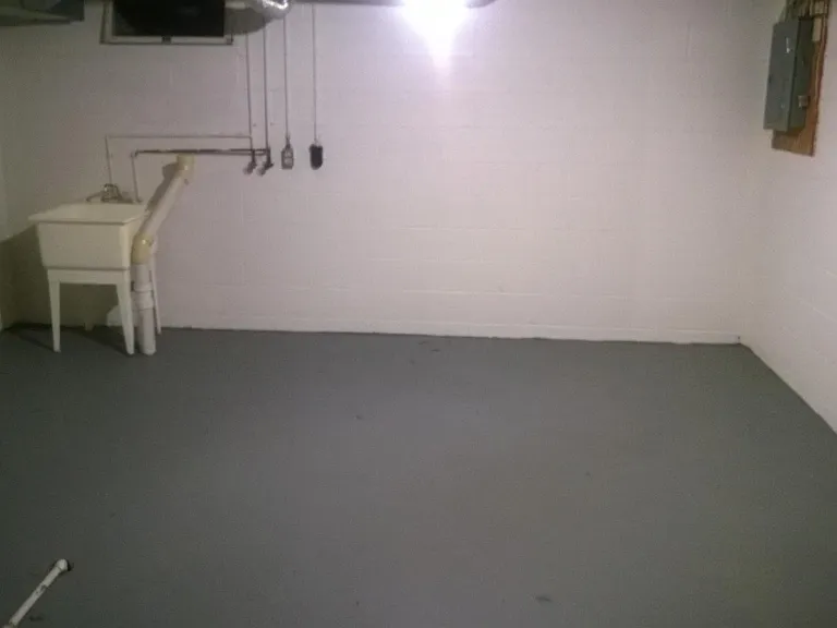 Unfinished basement for storage and laundry.
