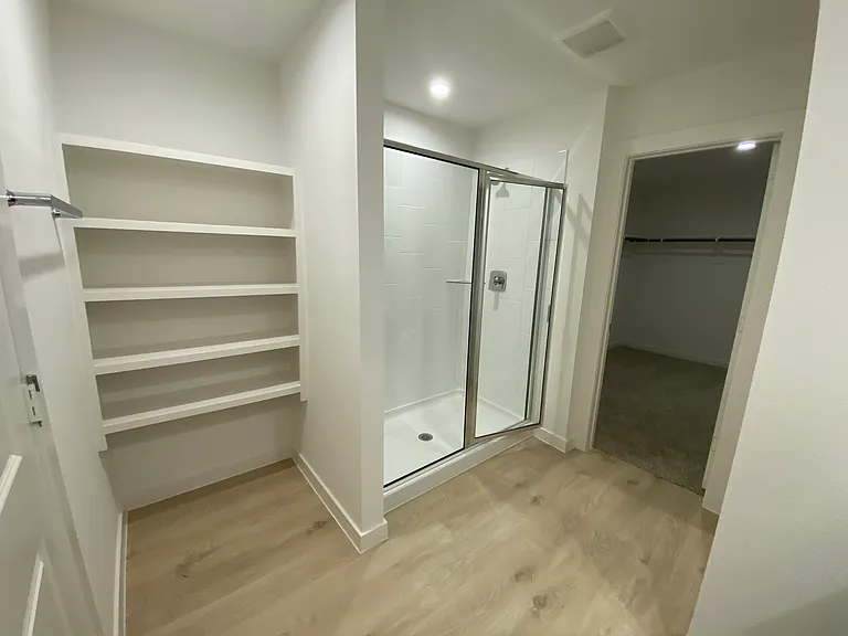 Master bathroom with large shower, additional storage space on the left