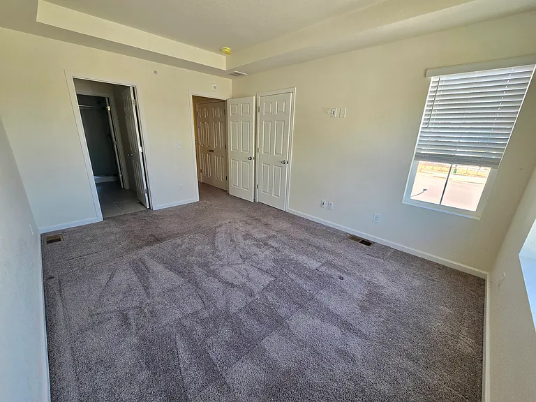 Master bedroom with bright natural lighting and in wall cable connections for TV or computer desk.