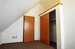 up stairs bedroom with private bathroom, closet and storage above closet