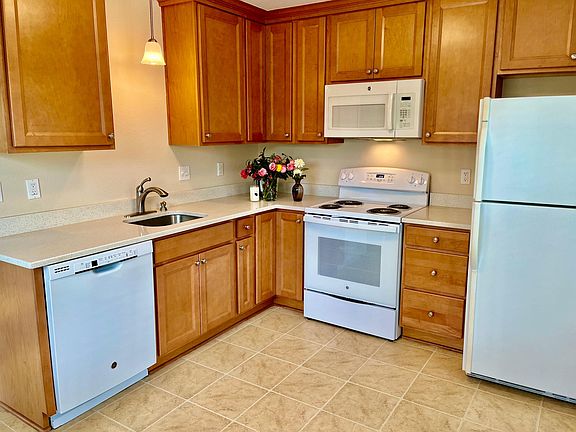 Kitchen with dishwasher, range, microwave, refrigerator