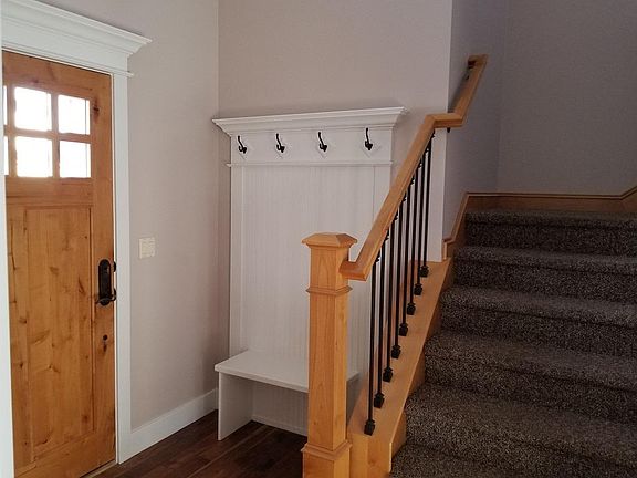 Hardwood entry with built in coat rack and bench
