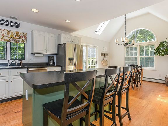 Elegantly appointed kitchen, featuring oversized island, dining area and an abundance of natural light.