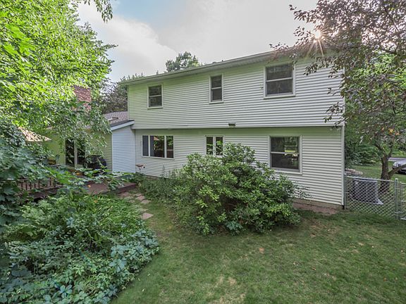 This view of the back of house, also shows the trees, shrubs, lawn in this totally fenced and very private back yard.  Surrounded by nature, it is restful and beautiful. 