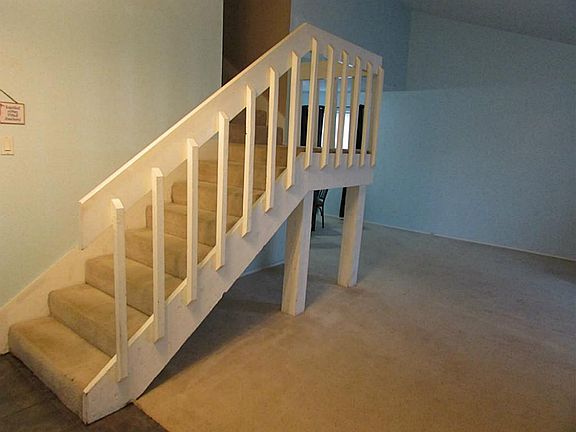 Convenient, wide staircase leading to living quarters upstairs.