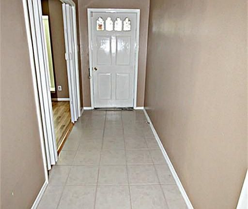 OPEN THE DOOR TO THE ENTRY WITH TILE FLOORS.