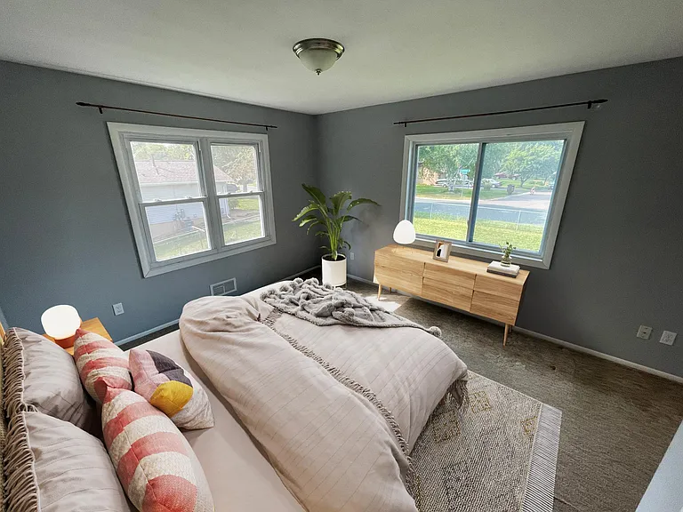 Master bedroom with a view of the neighborhood from the recently installed window.