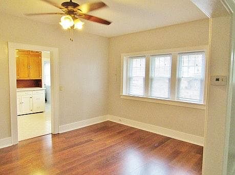 The dining room has new vinyl flooring with the look of hard