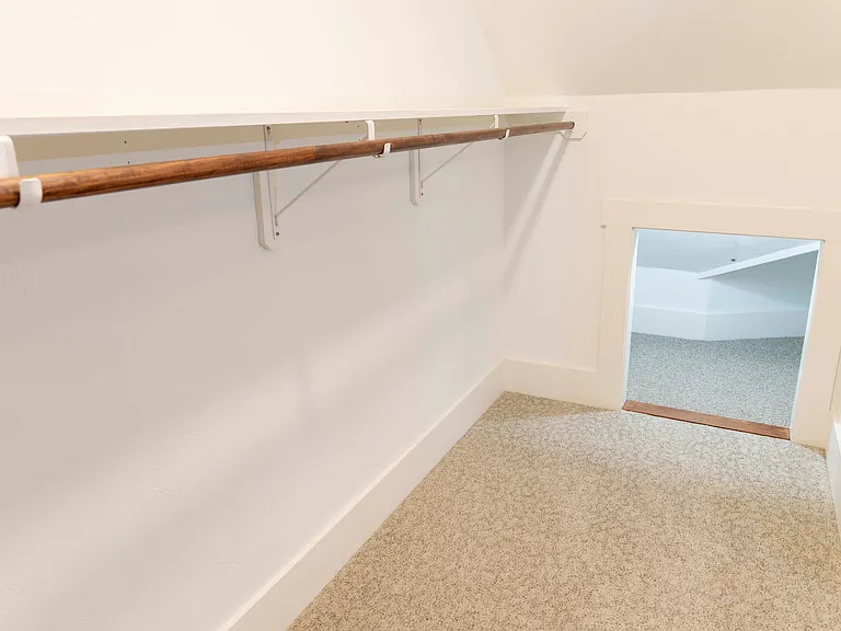 The bedroom closet has additional storage space on both sides.