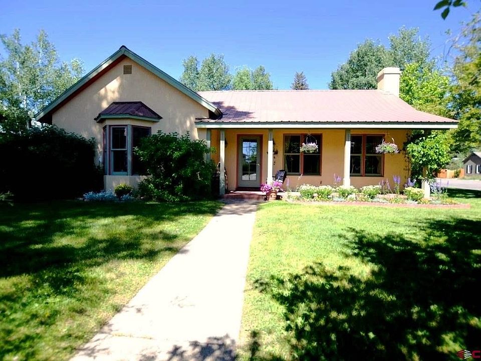 Shaded yard with beautiful flower beds greet you as you enter this wonderful updated Gunnison home.