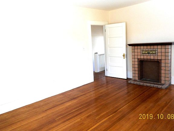 Extra large living room with original, decorative fireplace mantle