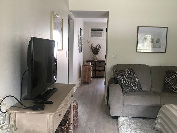 Living room looking into hall to dining area and kitchen