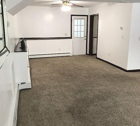 Dining room seen from Living room with one entrance to kitchen on right and door to 3 season porch.