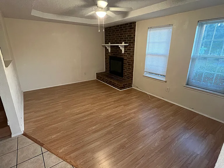 Living Room has working wood burning fire place over looks street