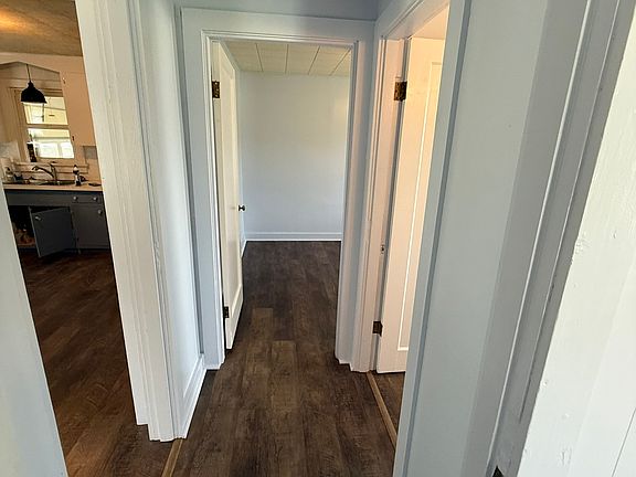Hallway with bedroom 2 in front, Bathroom to the right, and living room to the left