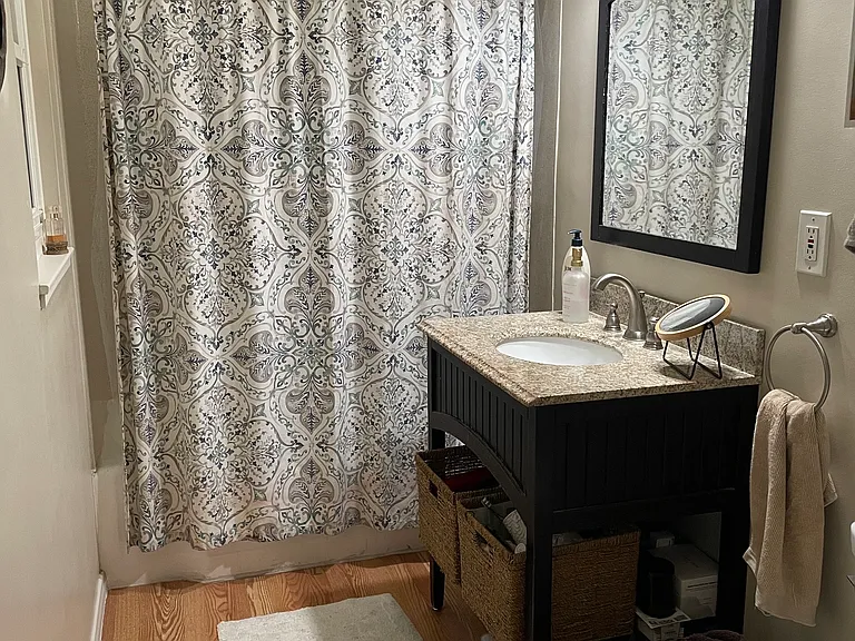 Bathroom with Tub/Shower off the bedroom hallway. Barn door installed for more space.