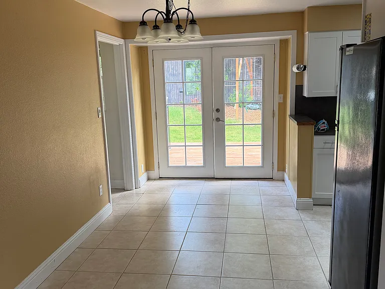 dining room with French doors that open onto deck in backyard