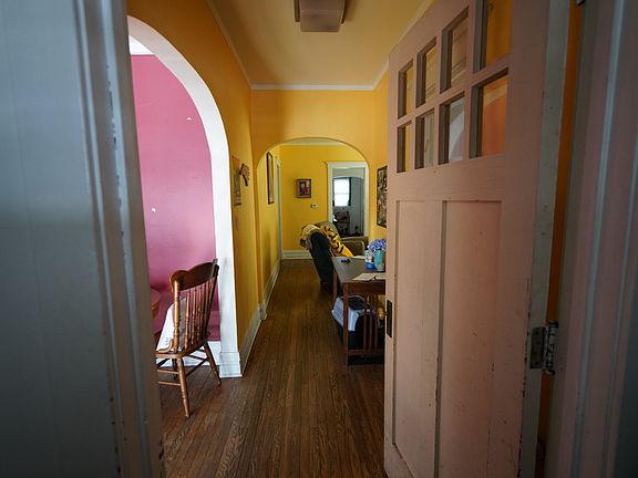 Inside the front entryway looking North Living Room (red) to the left and dining room in Yellow straight ahead with entry to the kitchen visible.