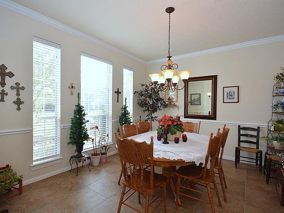 The dining room is large, very open and has great natural light for entertaining. Don't forget all the crown molding, the chair rail, and the rounded corners