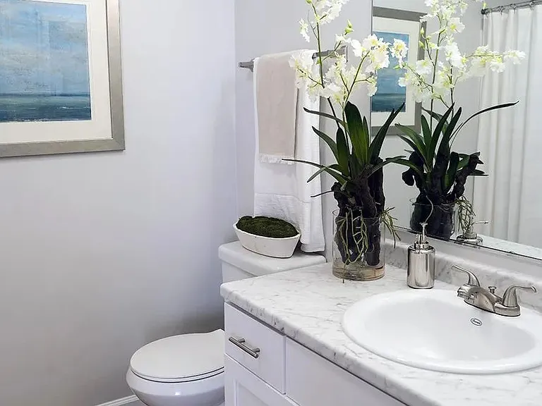 Our renovated bathrooms feature stunning marble-like countertops and gracious mirrors.