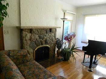 Stone fireplace in living room, very inviting.