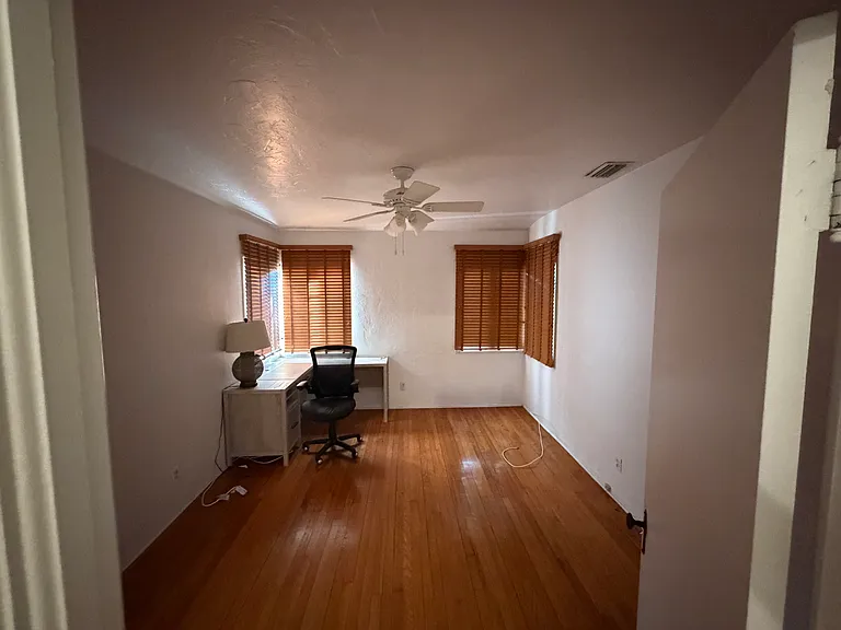 Rear BR, desk optional, windows with blinds open to the backyard